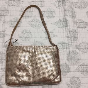 Espirit De Corp. brand gold shimmering bag.